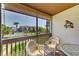 Cozy screened balcony features comfortable seating and a view of the community and pool at 6840 Midnight Pass Rd # 6840, Sarasota, FL 34242