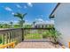 Balcony view overlooking the pool and tropical landscaping at 6840 Midnight Pass Rd # 6840, Sarasota, FL 34242