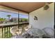 Relaxing screened balcony featuring comfortable wicker furniture and views of the community pool at 6840 Midnight Pass Rd # 6840, Sarasota, FL 34242
