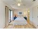 Bright bedroom featuring a ceiling fan, balcony access, and ensuite bathroom at 6840 Midnight Pass Rd # 6840, Sarasota, FL 34242