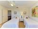 Well lit bedroom featuring two twin beds with ceiling fan and ample storage at 6840 Midnight Pass Rd # 6840, Sarasota, FL 34242