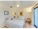 Comfortable bedroom featuring two twin beds, ceiling fan, and neutral décor at 6840 Midnight Pass Rd # 6840, Sarasota, FL 34242