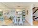Elegant dining area with a mirrored wall, an elegant chandelier, and open access to the kitchen at 6840 Midnight Pass Rd # 6840, Sarasota, FL 34242