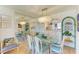 Bright dining room featuring a mirrored wall and a stylish chandelier, with a view into the adjacent kitchen at 6840 Midnight Pass Rd # 6840, Sarasota, FL 34242
