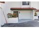 Charming condo featuring an attached garage, white stucco, and a red tile roof, surrounded by well-maintained landscaping at 6840 Midnight Pass Rd # 6840, Sarasota, FL 34242