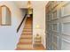 Inviting foyer features a beautifully crafted front door, stylish lighting, and a staircase leading to the upper level at 6840 Midnight Pass Rd # 6840, Sarasota, FL 34242