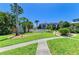 Well-manicured community grounds featuring lush landscaping, walkways, and a sparkling pool at 6840 Midnight Pass Rd # 6840, Sarasota, FL 34242