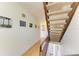 Hallway features wood floors, stairway, and artwork on the white walls at 6840 Midnight Pass Rd # 6840, Sarasota, FL 34242