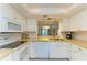 Well-lit kitchen features white cabinets, modern appliances, and lots of counter space at 6840 Midnight Pass Rd # 6840, Sarasota, FL 34242
