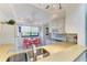 Bright kitchen with white cabinetry, modern appliances, eat-in dining area, and a window at 6840 Midnight Pass Rd # 6840, Sarasota, FL 34242
