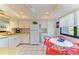 White kitchen with ample counter space, modern appliances, and a breakfast nook at 6840 Midnight Pass Rd # 6840, Sarasota, FL 34242