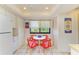 Kitchen area includes a table with red chairs and white cabinetry with stainless appliances at 6840 Midnight Pass Rd # 6840, Sarasota, FL 34242