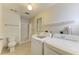Full laundry setup with washer, dryer, sink, and additional space with toilet and shower at 6840 Midnight Pass Rd # 6840, Sarasota, FL 34242