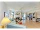 Bright living room with hardwood floors, a decorative fireplace, and sliding glass doors to outdoor patio at 6840 Midnight Pass Rd # 6840, Sarasota, FL 34242