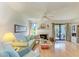 Cozy living room with hardwood floors, fireplace, and sliding door access to the outdoor patio at 6840 Midnight Pass Rd # 6840, Sarasota, FL 34242