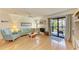 Bright living room features a decorative fireplace, hardwood floors, and sliding glass doors opening to a patio area at 6840 Midnight Pass Rd # 6840, Sarasota, FL 34242