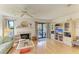 Bright living room features hardwood floors, fireplace, and sliding glass doors to a patio at 6840 Midnight Pass Rd # 6840, Sarasota, FL 34242