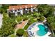 Aerial view of a beautiful condo community, lush landscaping and a refreshing pool at 6840 Midnight Pass Rd # 6840, Sarasota, FL 34242
