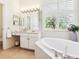 Inviting bathroom with a corner soaking tub and dual sinks at 6851 Bay Hill Dr, Lakewood Ranch, FL 34202