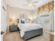 Comfortable bedroom with neutral decor, a ceiling fan, and a window view at 6851 Bay Hill Dr, Lakewood Ranch, FL 34202