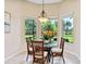 Bright breakfast nook with large windows and a charming chandelier at 6851 Bay Hill Dr, Lakewood Ranch, FL 34202