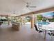 Stylish covered outdoor seating with kitchen and barbecue grill, providing a perfect space to enjoy Florida living at 6851 Bay Hill Dr, Lakewood Ranch, FL 34202