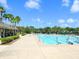 Large community swimming pool area with multiple lanes, lush landscaping, and ample deck space for residents at 6851 Bay Hill Dr, Lakewood Ranch, FL 34202