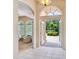 Inviting foyer featuring tiled floors, archways, and a view of the manicured yard at 6851 Bay Hill Dr, Lakewood Ranch, FL 34202