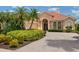 Charming home featuring a tile roof, lush landscaping and a brick-paved driveway at 6851 Bay Hill Dr, Lakewood Ranch, FL 34202