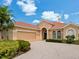 Charming home featuring a tile roof, lush landscaping and a brick-paved driveway at 6851 Bay Hill Dr, Lakewood Ranch, FL 34202