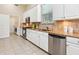 Modern kitchen featuring stainless steel appliances, granite countertops, and ample cabinet space at 6851 Bay Hill Dr, Lakewood Ranch, FL 34202