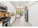 Open kitchen featuring stainless steel appliances, white cabinetry, and an eat-in breakfast nook at 6851 Bay Hill Dr, Lakewood Ranch, FL 34202