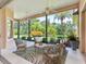 Relaxing screened lanai with ceiling fans and views of the lush tropical backyard at 6851 Bay Hill Dr, Lakewood Ranch, FL 34202