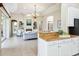 Spacious living room with built-in bookshelves, fireplace, and granite countertops at 6851 Bay Hill Dr, Lakewood Ranch, FL 34202