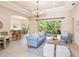Open-concept living room with tile flooring, tray ceilings, and views of the backyard at 6851 Bay Hill Dr, Lakewood Ranch, FL 34202