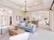 Spacious living room with neutral tones, modern lighting, and an open floor plan at 6851 Bay Hill Dr, Lakewood Ranch, FL 34202