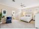 Bright main bedroom with ceiling fan, ensuite bathroom, and plush carpet at 6851 Bay Hill Dr, Lakewood Ranch, FL 34202