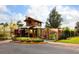 Unique mini golf entrance with a rustic wooden structure, lush landscaping, and a charming atmosphere at 6851 Bay Hill Dr, Lakewood Ranch, FL 34202