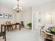 Spacious office area with desk, chandelier, and open doorway to adjacent room at 6851 Bay Hill Dr, Lakewood Ranch, FL 34202