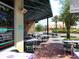 Relaxing outdoor dining area with a covered patio, tables and chairs, and views of the surrounding scenery at 6851 Bay Hill Dr, Lakewood Ranch, FL 34202