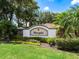 Community sign for Gleneagles surrounded by lush greenery and colorful flowers at 6851 Bay Hill Dr, Lakewood Ranch, FL 34202