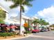 Street view of buildings with beautiful architectural details, lush greenery, palm trees, and street parking available at 6851 Bay Hill Dr, Lakewood Ranch, FL 34202