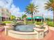 Charming town center with a decorative fountain, palm trees, and inviting storefronts for community enjoyment at 6851 Bay Hill Dr, Lakewood Ranch, FL 34202