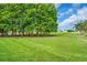 Expansive backyard bordering a golf course surrounded by mature trees at 6908 Stoneywalk Ct, Bradenton, FL 34203