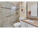 Modern bathroom with glass-enclosed shower, granite countertop vanity, and neutral tile, offering a spa-like experience at 6908 Stoneywalk Ct, Bradenton, FL 34203