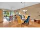 Cozy dining area with a glass table, bright chairs, and view of the backyard at 6908 Stoneywalk Ct, Bradenton, FL 34203