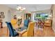 Bright dining area featuring elegant table set, glass doors, and views of the lush backyard at 6908 Stoneywalk Ct, Bradenton, FL 34203