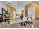 Open-concept kitchen featuring granite countertops, stainless steel appliances, and a breakfast bar at 6908 Stoneywalk Ct, Bradenton, FL 34203