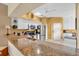 Well-lit kitchen with stainless steel appliances, granite countertops, and modern lighting at 6908 Stoneywalk Ct, Bradenton, FL 34203
