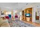 Comfortable living room with stylish decor, entertainment center, and hardwood floors, perfect for relaxing or entertaining guests at 6908 Stoneywalk Ct, Bradenton, FL 34203